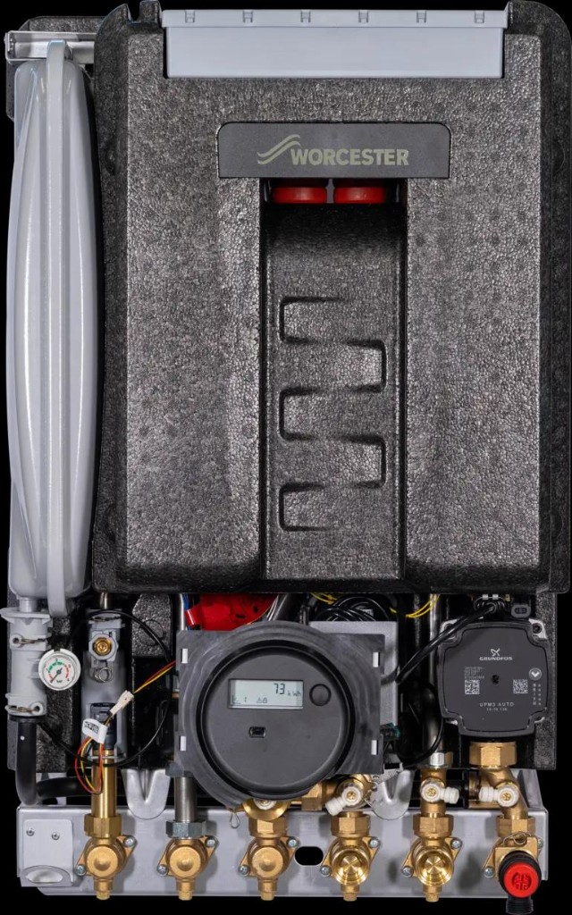 Interior of a Worcester Bosch heat interface unit showing the insulation, Grundfos pump, digital energy meter and brass connections.