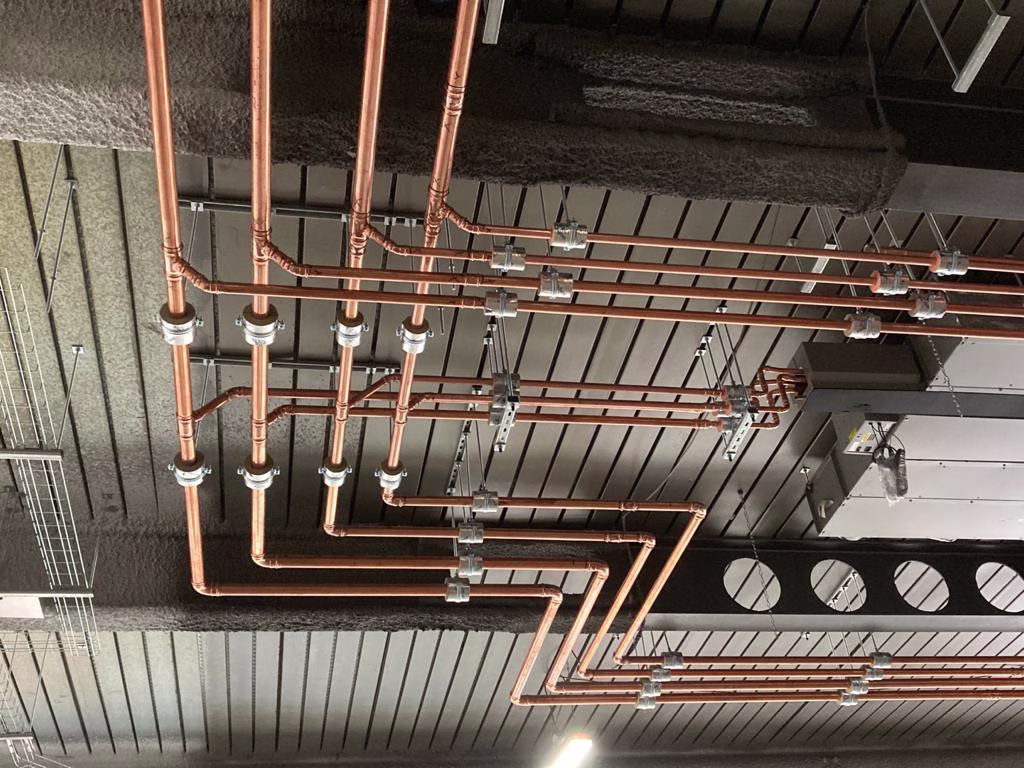 Commercial copper pipework installed on a ceiling with HVAC services