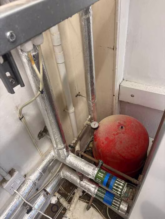 Red Zilmet heating expansion vessel in the corner of a Westminster plant room